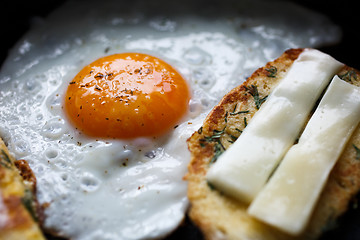 Image showing fried egg and bread with cheese