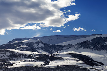 Image showing Snowy sunlight mountains at sun evening