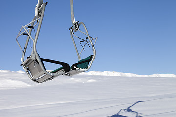 Image showing Chair-lift in ski resort at sun day after snowfall