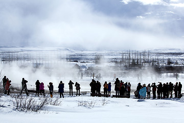 Image showing Tourists at the famous geyser Strokkur, Iceland