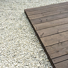 Image showing Wooden deck and white decorative stones