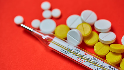 Image showing Mercury thermometer and medical pills on background