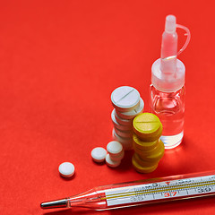 Image showing Mercury thermometer and medical pills on background