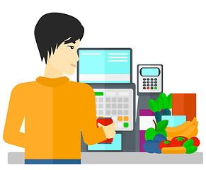 Image showing Cashier at supermarket checkout.