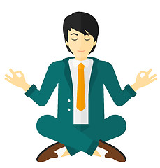 Image showing Businessman meditating in lotus pose.