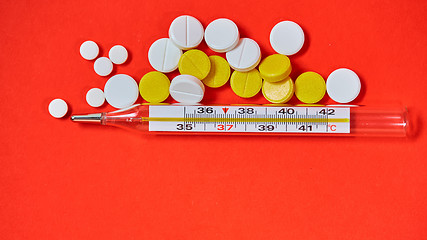 Image showing Mercury thermometer and medical pills on background