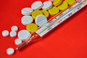 Image showing Mercury thermometer and medical pills on background