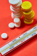 Image showing Mercury thermometer and medical pills on background