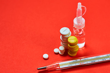 Image showing Mercury thermometer and medical pills on background