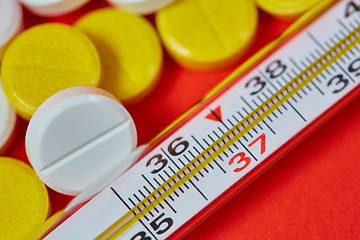 Image showing Mercury thermometer and medical pills on background