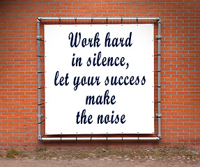 Image showing Large banner with inspirational quote on a brick wall