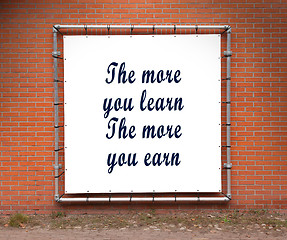 Image showing Large banner with inspirational quote on a brick wall