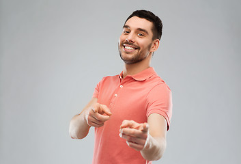 Image showing man pointing finger to you over gray background