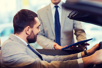 Image showing happy man with car dealer in auto show or salon