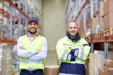 Image showing men in uniform with boxes at warehouse