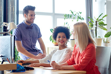 Image showing happy creative team talking in office