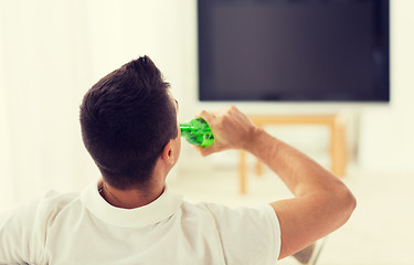 Image showing man watching tv and drinking beer at home