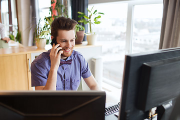 Image showing happy creative male worker calling on smarphone