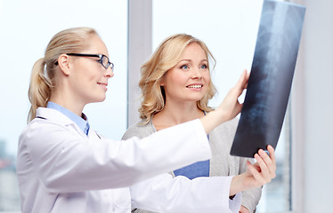 Image showing woman patient and doctor with spine x-ray scan