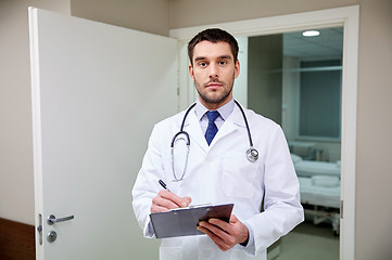 Image showing doctor with stethoscope and clipboard at hospital