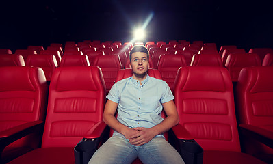 Image showing happy young man watching movie in theater