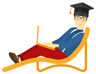 Image showing Graduate lying on chaise lounge with laptop.