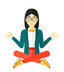 Image showing Business woman meditating in lotus pose.