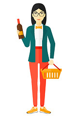 Image showing Customer with shopping basket and bottle of wine.