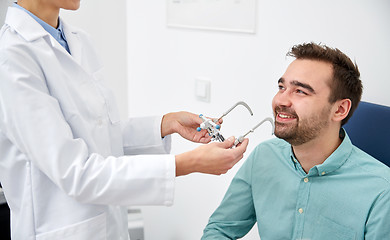 Image showing optician with trial frame and patient at clinic