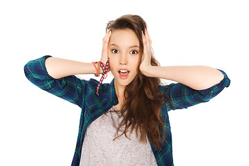 Image showing happy pretty teenage girl holding to head