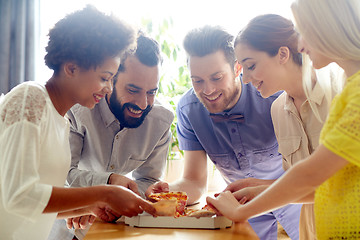 Image showing happy business team eating pizza in office