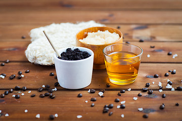 Image showing close up of coffee scrub in cup and honey on wood