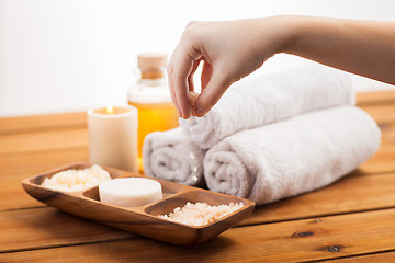 Image showing close up of hand with pink salt and bath stuff