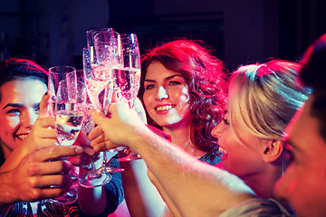 Image showing smiling friends with glasses of champagne in club