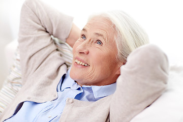 Image showing happy senior woman resting on sofa at home