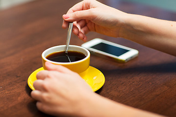 Image showing close up of woman with smartphone and coffee