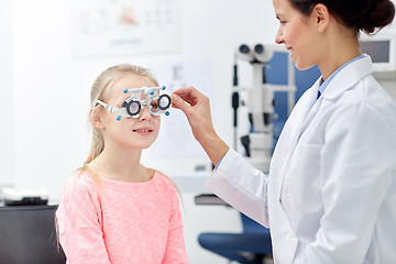 Image showing optician with trial frame and girl at clinic