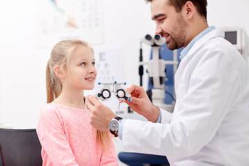 Image showing optician with trial frame and girl at clinic