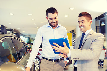 Image showing happy man with car dealer in auto show or salon