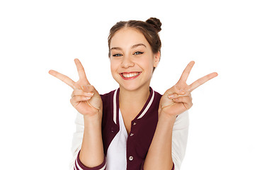 Image showing happy smiling teenage girl showing peace sign