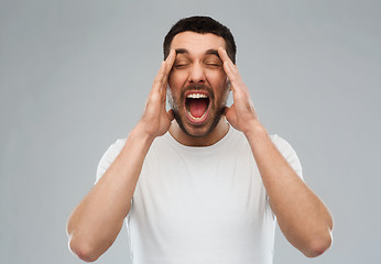 Image showing crazy shouting man in t-shirt over gray background