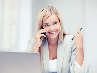 Image showing businesswoman with laptop and cell phone