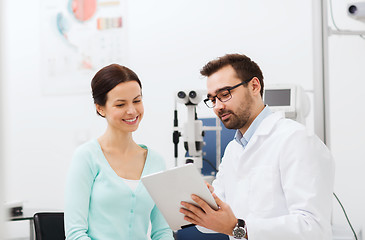 Image showing optician with tablet pc and patient at eye clinic