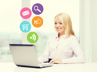 Image showing smiling businesswoman or student with laptop