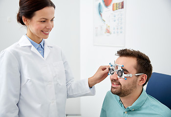 Image showing optician with trial frame and patient at clinic