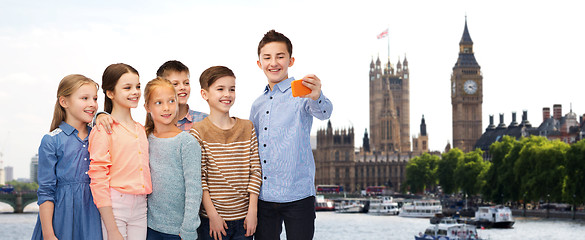 Image showing happy children talking selfie by smartphone