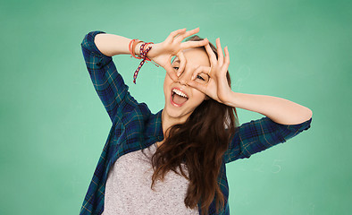 Image showing happy teenage student girl having fun over green