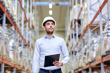 Image showing happy businessman with clipboard at warehouse