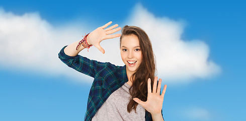 Image showing happy smiling pretty teenage girl showing hands