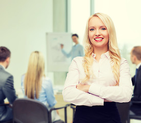 Image showing smiling businesswoman or secretary in office